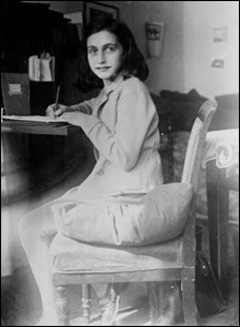 Anne Frank writing at her desk at home at the Merwedeplein, 1941